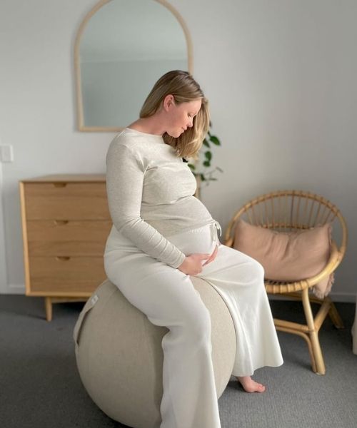 pregnant woman sitting on esfera fabric ball chair