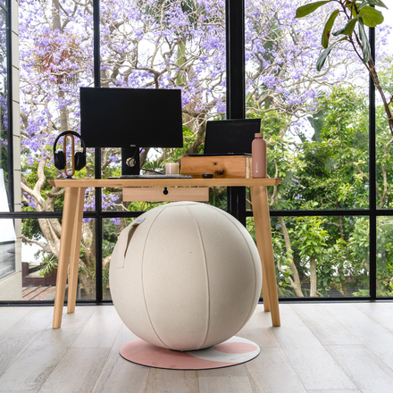 stylish home office workspace with fabric covered exercise ball
